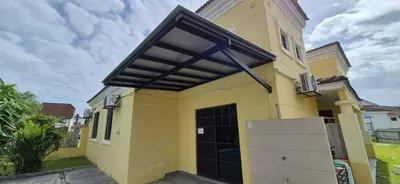 a yellow house with a black roof at Striatus by Holiday Pool Villa A'Famosa Resort in Gua Sai