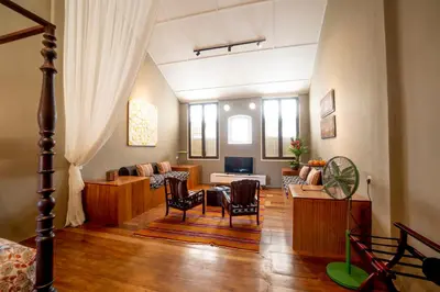 a living room with a couch and a table and chairs at Argus Residences in George Town