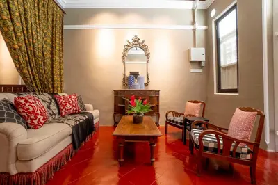 a living room with a couch and a table at Argus Residences in George Town
