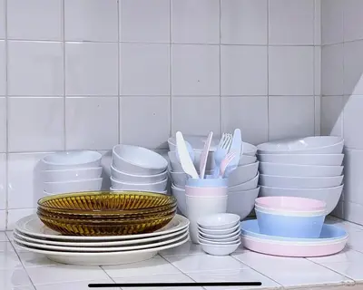 a pile of plates and bowls and utensils in a kitchen at Pearl Cottage - 2min Drive to Lam Wah Ee Hospital in George Town