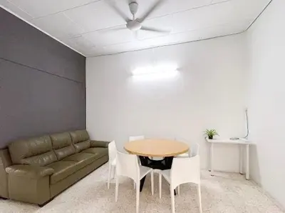 a living room with a couch and a table and chairs at Pearl Cottage - 2min Drive to Lam Wah Ee Hospital in George Town