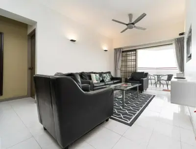 a living room with a couch and a table at Seaview 3 room Apartment Batu Ferringhi in Batu Ferringhi