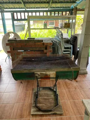 a bench sitting on a table on a patio at Galeri Merah Teratak Anak Amas in Sungai Besar