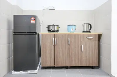 a kitchen with a black refrigerator and wooden cabinets at Perfect for Families & Friends, Retreat Brinchang Cameron Highland- Clover Home 2-20 in Brinchang