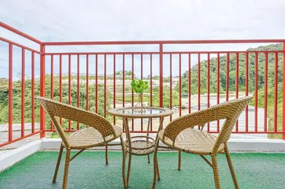 a table and two chairs on a balcony at Perfect for Families & Friends, Retreat Brinchang Cameron Highland- Clover Home 2-20 in Brinchang