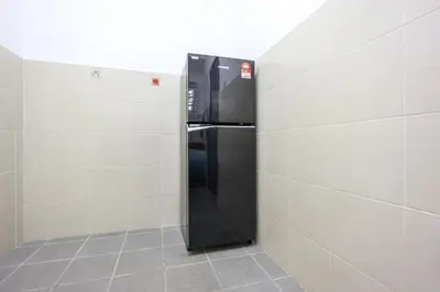 a black refrigerator in the corner of a room at Homestay Emerald Avenue Brinchang Cameron Highlands For 12 Pax Clover Home G23A in Brinchang