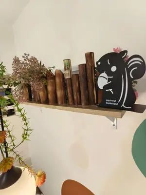 a shelf on the wall with a black bear and a bunch of cigars at Unisuites Kampar 5 min UTAR & TARC -1 BR 3pax PetFriendly, 1 Carpark & Netflix I High Floor Unblock Mountain View in Kampar