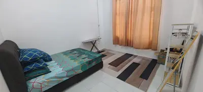 a living room with a couch and a window at ZARI Homestay Kamunting in Gua Sai