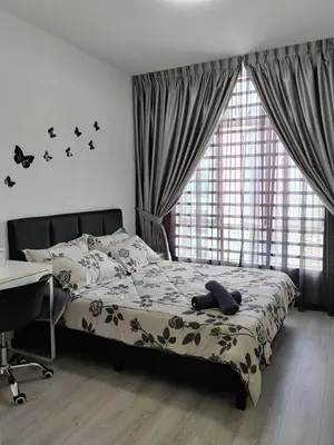 a bedroom with a bed and a desk and a window at The Anderson by Triple G Homes in Ipoh