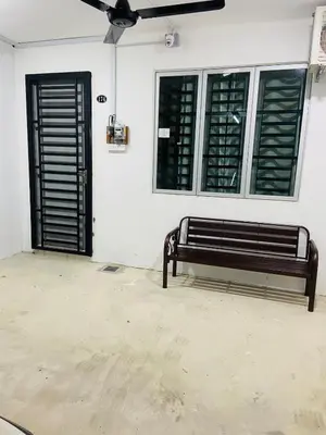 a black bench sitting in front of a door at Baitul Mikhael Homestay in Kampong Ayer Melintas Besar