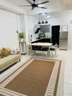 a living room with a couch and a table at Baitul Mikhael Homestay in Kampong Ayer Melintas Besar