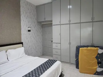 a bedroom with a bed and white cabinets at Ipoh Tambun pool villa 5br 18pax bbq mahjong in Tambun