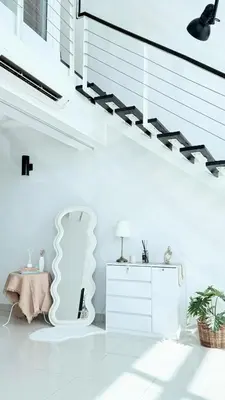a white room with a staircase with a lamp and a dresser at Maritime Suite Full Seaview Georgetown in George Town