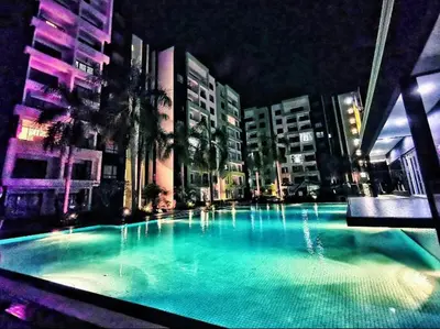 a large swimming pool in a city at night at Ipoh Manhattan Waterpark Suite by City Home Empire MHB403 in Ipoh