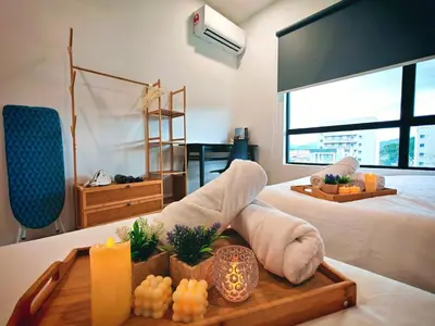 a hotel room with a bed and a tray with towels at Ipoh Manhattan Waterpark Suite by City Home Empire MHB403 in Ipoh