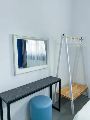 a mirror and a table with a blue stool at Santorini Canning Garden in Ipoh