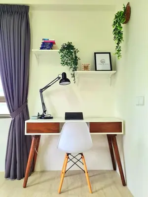 a desk with a lamp and a white chair at By The Sea - Beachfront Bliss at Batu Ferringhi in Batu Ferringhi