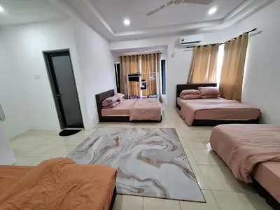a room with three beds and a rug in it at Zehra Villa Seri Iskandar with Private Pool in Seri Iskandar