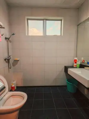 a bathroom with a toilet and a sink and a window at Tower Regency Hotel & Apartments in Ipoh
