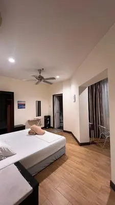 a bedroom with two beds and a ceiling fan at Tower Regency Hotel & Apartments in Ipoh