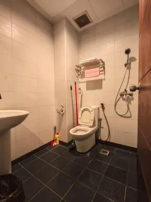 a bathroom with a toilet and a sink at Tower Regency Hotel & Apartments in Ipoh