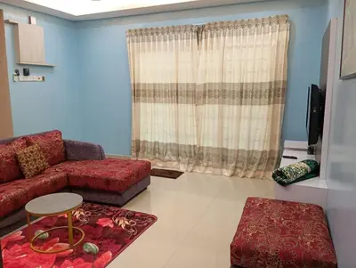 a living room with a couch and a table at HD Jaya Shine Homestay in Sungai Petani