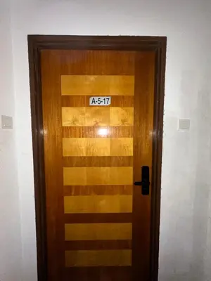 a wooden door with a sign on it at Homestay in Marina Heights with beach view in Lumut