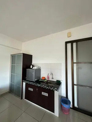 a kitchen with a sink and a microwave in it at Homestay in Marina Heights with beach view in Lumut