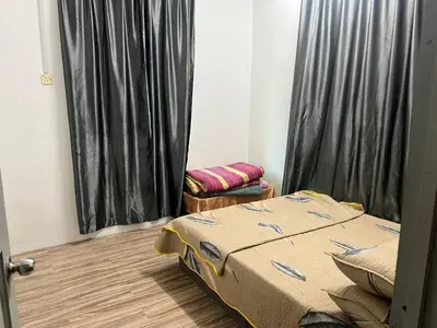 a bedroom with a bed and a window with black curtains at RZ HOMESTAY With WiFi in Sungai Siput