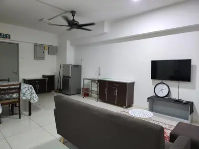 a living room with a couch and a flat screen tv at Family Haven at Paragon in Gua Sai
