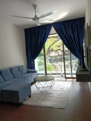 a living room with a blue couch and a table at Ereens homestay Cameron highland in Brinchang