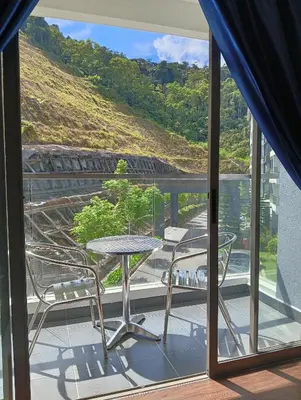 a patio with a table and chairs on a balcony at Ereens homestay Cameron highland in Brinchang