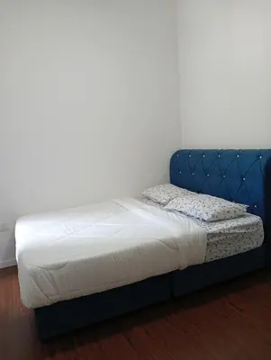 a bed in a room with a blue bed frame at Ereens homestay Cameron highland in Brinchang