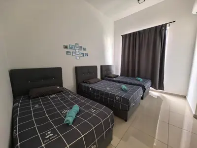 a bedroom with two beds and a window at Padang Serai Wangi Homestay 63 in Padang Serai