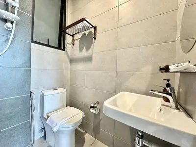 a bathroom with a white toilet and a sink at Urban Suites #Tiny walnut 2BR1bath suite #Infinity Pool #4pax #2 Queens #Quality well maintained #Private host in Jelutong