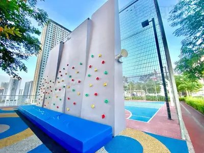 a climbing wall with a blue bench next to a pool at Urban Suites #Tiny walnut 2BR1bath suite #Infinity Pool #4pax #2 Queens #Quality well maintained #Private host in Jelutong