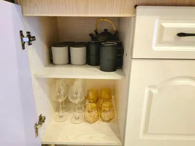 a cupboard with wine glasses and bottles in it at #MyHillsideHideaway at Quintet, Cameron Highlands in Tanah Rata
