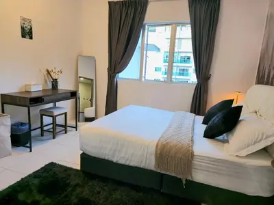 a bedroom with a bed and a desk and a window at #MyHillsideHideaway at Quintet, Cameron Highlands in Tanah Rata