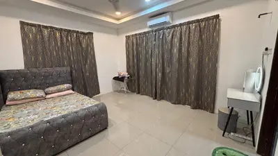 a bedroom with a bed and curtains and a desk at Healing Homestay in Kampong Changkat Sedonan