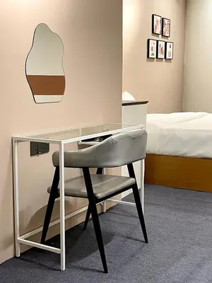 a desk with a chair in a room with a bed at Bali Nordic American Guest House Style By Nest at Beach St George Town Penang in George Town