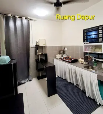 a kitchen with a sink and a running appliance at 1132 D' KHASIEH Homestay in Kampong Sungai Wangi Dalam