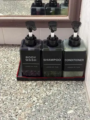 three bottles of soap sitting next to a window at Sky beach resort in Tanjung Bungah