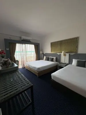 a hotel room with two beds and a window at Sky beach resort in Tanjung Bungah