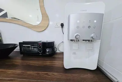 a white coffee machine sitting next to a microwave at Cozy Villa - Private Pool, 5BR, KTV, BBQ, PS5 just 3 Mins to Batu Ferringhi Beach! in Batu Ferringhi