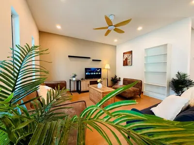 a living room with couches and a ceiling fan at WhiteZen Family Homestay 9Room for 20pax Central Penang in Jelutong