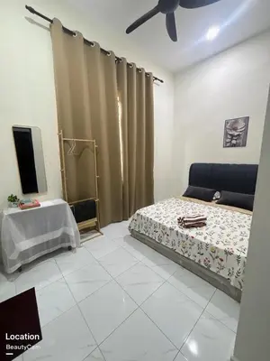 a bedroom with a bed and a tv in it at Aisyah Homestay in Kuala Ketil