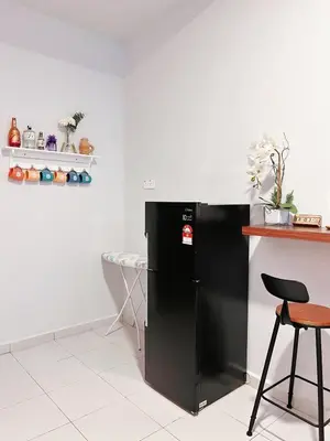 a kitchen with a black refrigerator and a table at Sitiawan 2-storey 4room5BedsWifi 10pax near Jetty in Sitiawan