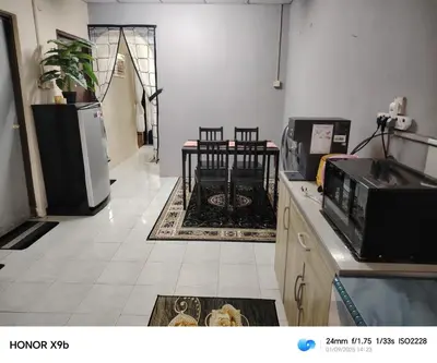 a room with a kitchen with a refrigerator and a table at Ed 02 manjung in Seri Manjung