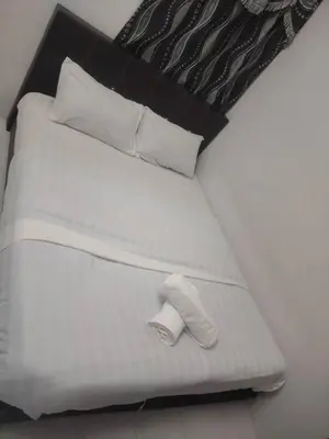 a white bed with a sock on top of it at Dynamic smartstay in Ipoh