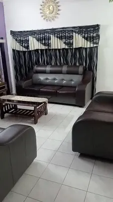 a living room with a leather couch and a coffee table at Dynamic smartstay in Ipoh
